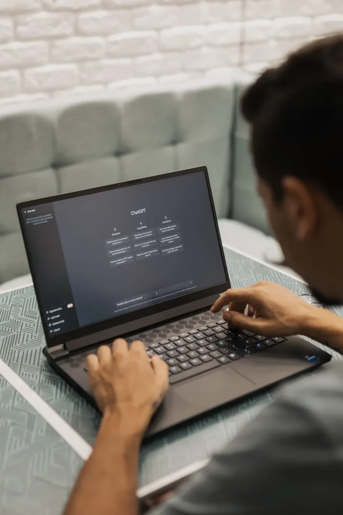 Apa itu AI website builder, pria mengetik prompt di laptop